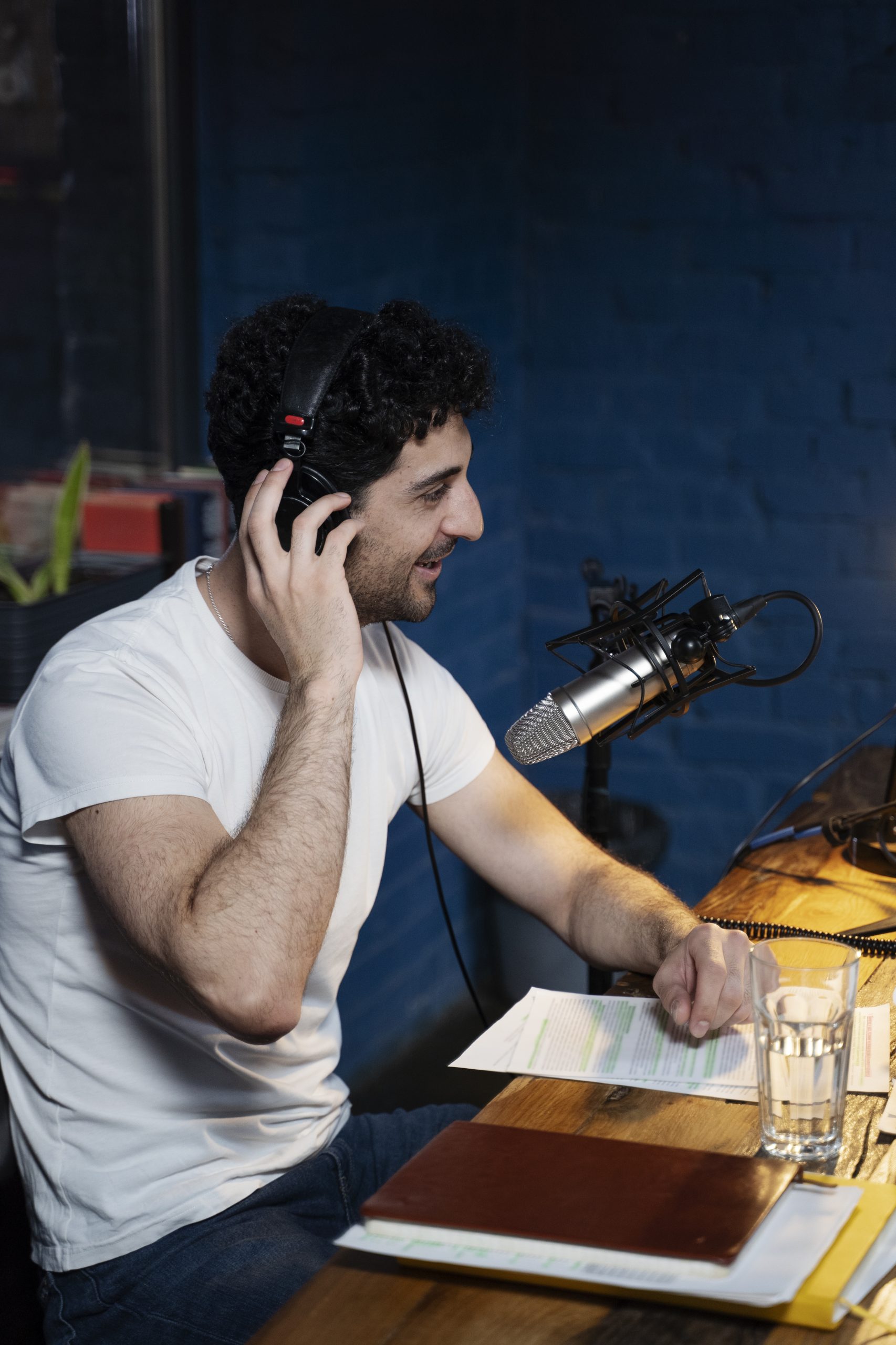man-with-microphone-headphones-running-podcast-studio